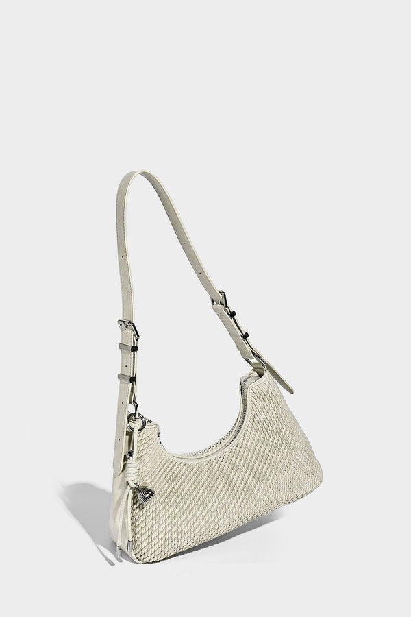Woven crescent hobo shoulder bag with smooth side panels, zip-top closure, silver-tone charm hardware, and adjustable, detail