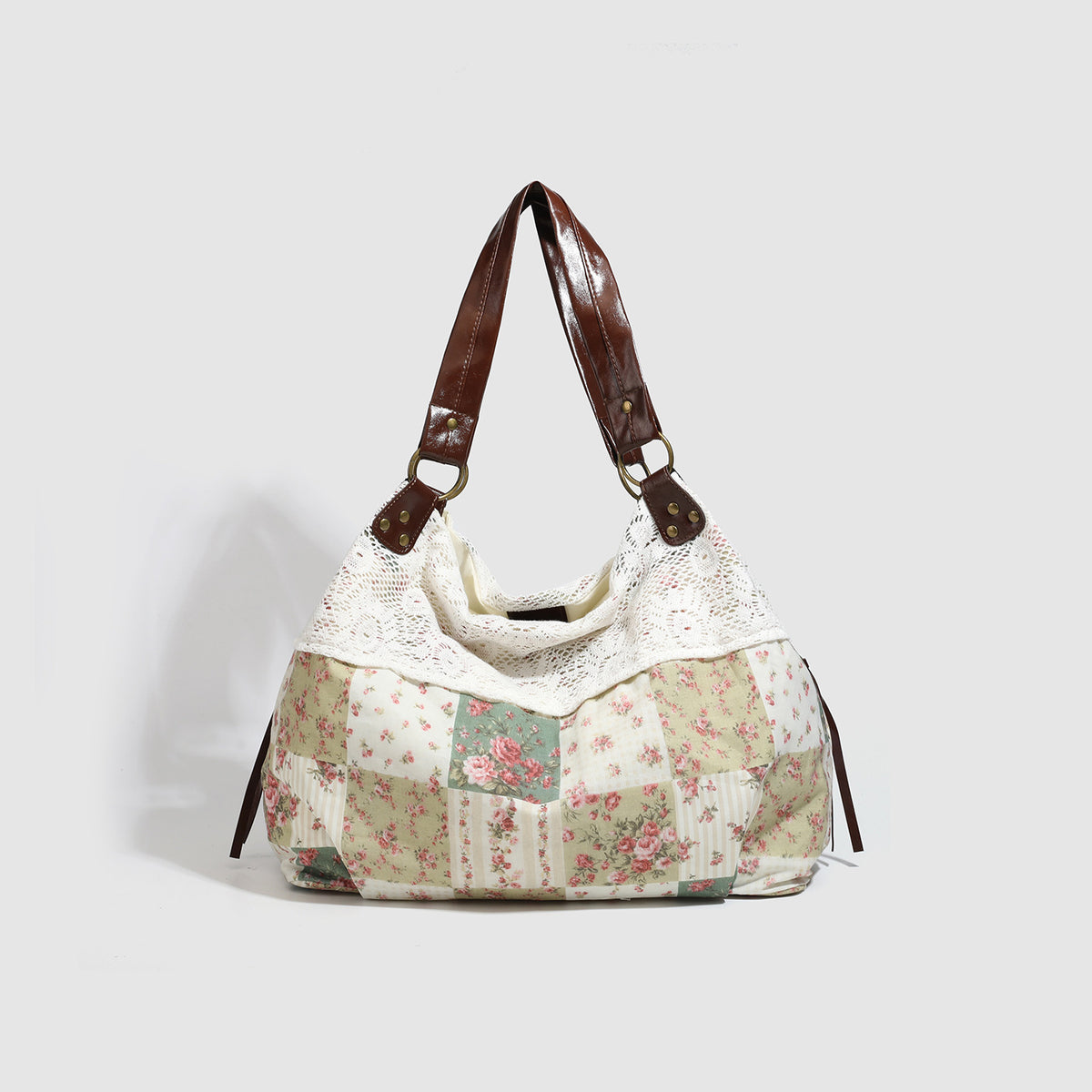 Cream floral patchwork hobo tote bag with crochet lace trim and brown leather-look shoulder straps, front view