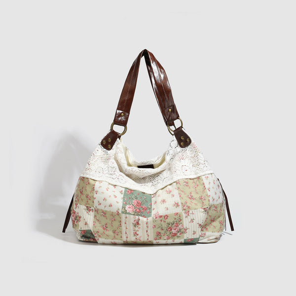 Cream floral patchwork hobo tote bag with crochet lace trim and brown leather-look shoulder straps, front view