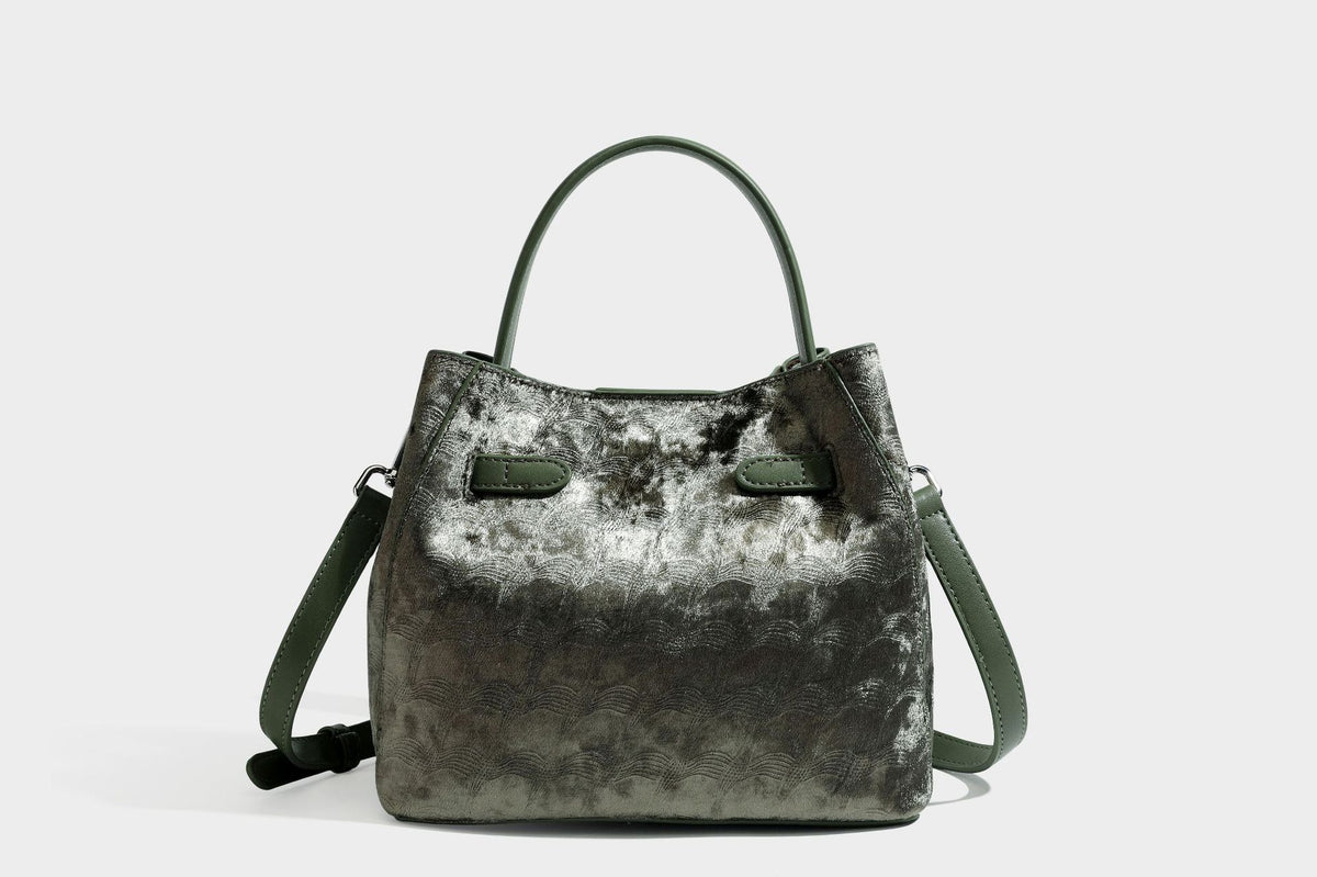 Small structured bucket satchel in embossed velvet-texture fabric with silver turn-lock hardware, rounded top handle, and