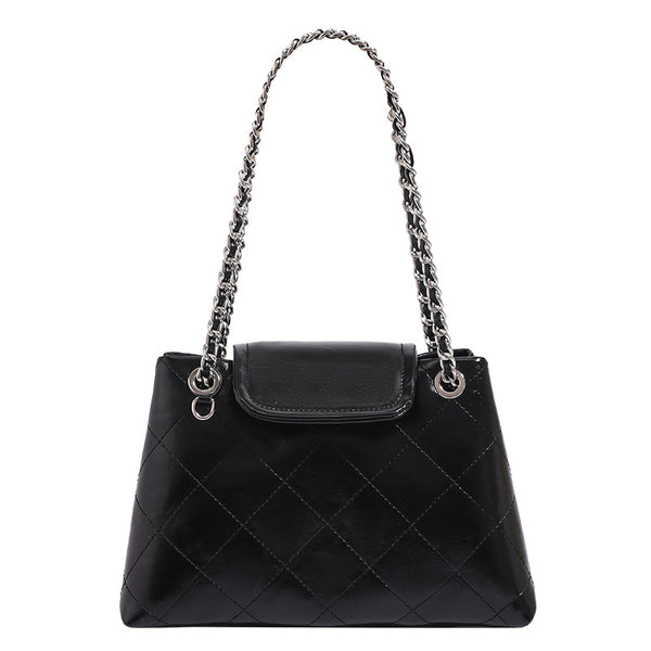 Quilted trapezoid shoulder bag with chain straps, flap closure, and ring hardware, detail view 5