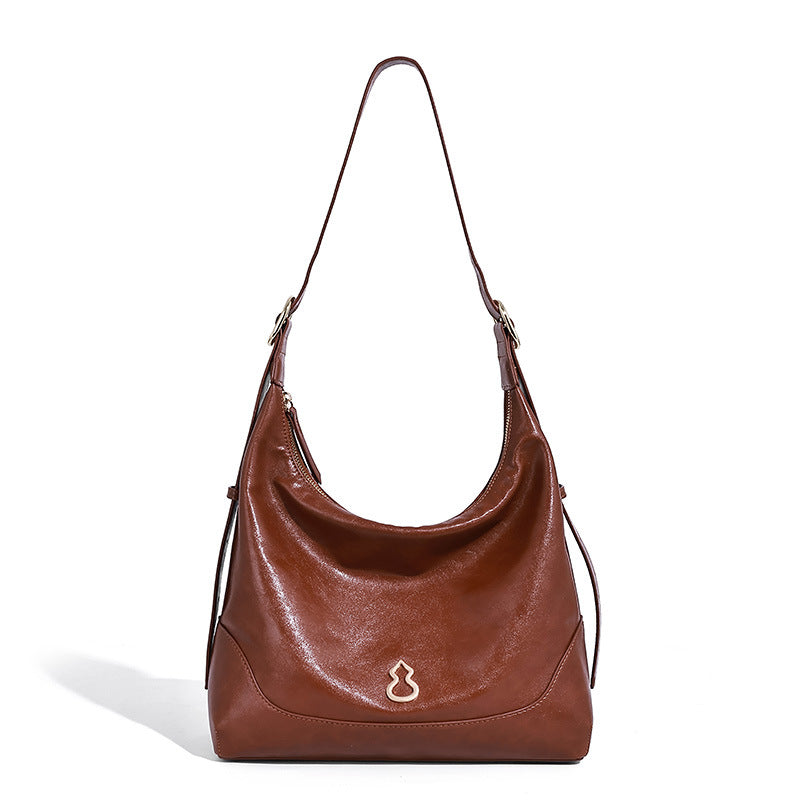 Glossy leather-look slouchy hobo shoulder bag with zip closure, gold-tone hardware, and adjustable strap, detail view 5