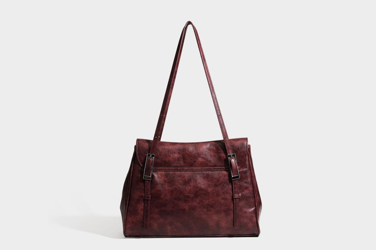 Structured flap-top shoulder tote bag in distressed leather-look finish with silver-tone buckle hardware and double shoulder