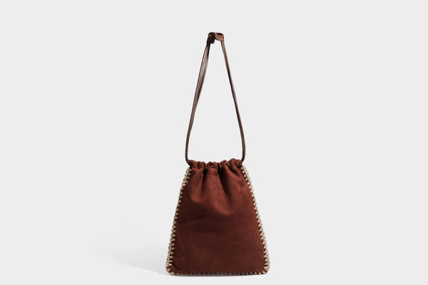 Matte suede-look drawstring bucket bag with cream braided woven edge trim and slim adjustable leather-look shoulder strap