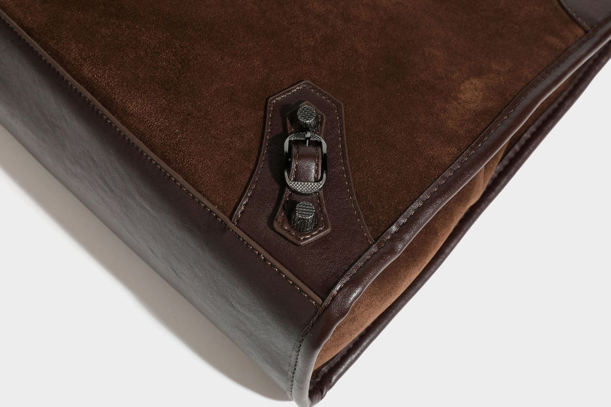 Large structured tote bag with matte suede-like body, smooth leather-look trim, front zip pocket, stud hardware, and