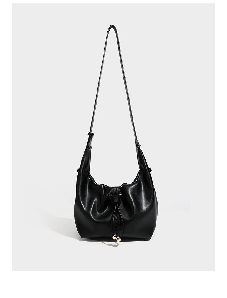 Slouchy hobo bag with smooth leather-look finish, drawstring cinch closure, and gold-tone bead hardware, detail view 7