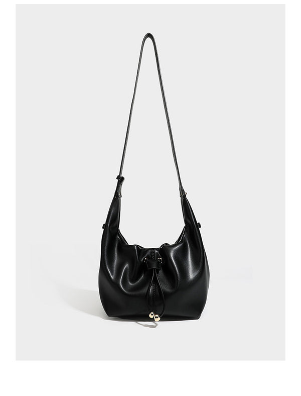 Slouchy hobo bag with smooth leather-look finish, drawstring cinch closure, and gold-tone bead hardware, detail view 7