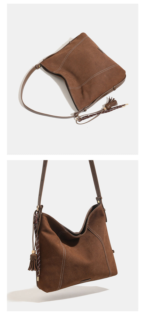 Slouchy suede-finish hobo shoulder bag in warm mocha brown with contrast stitching, braided tassel side accent, and, detail