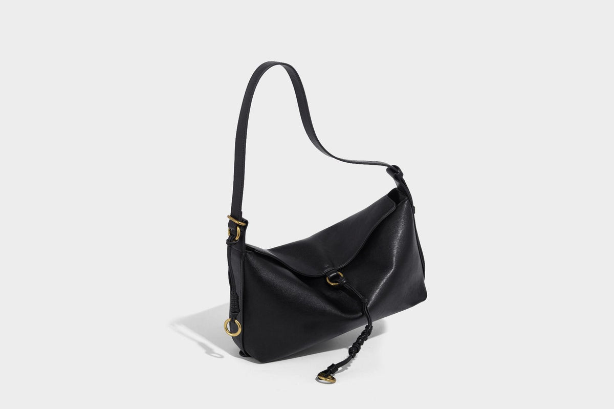 Slouchy brown leather-look shoulder bag with knotted drawcord tie closure, gold-tone ring hardware, and long adjustable
