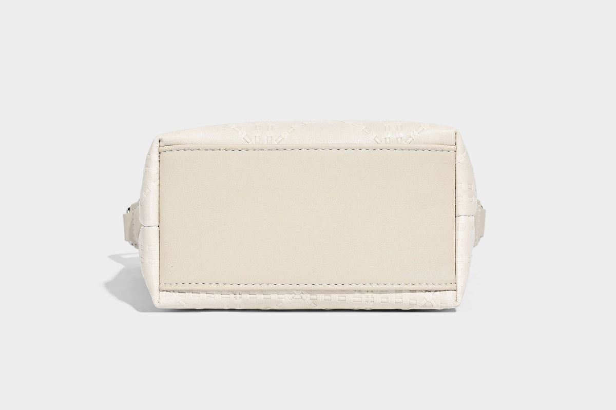 Small embossed half-moon shoulder bag with top zipper, detachable front pouch, and adjustable slim strap, detail view 16