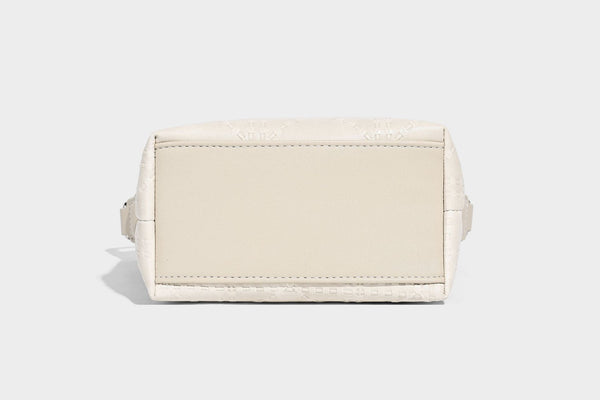 Small embossed half-moon shoulder bag with top zipper, detachable front pouch, and adjustable slim strap, detail view 16