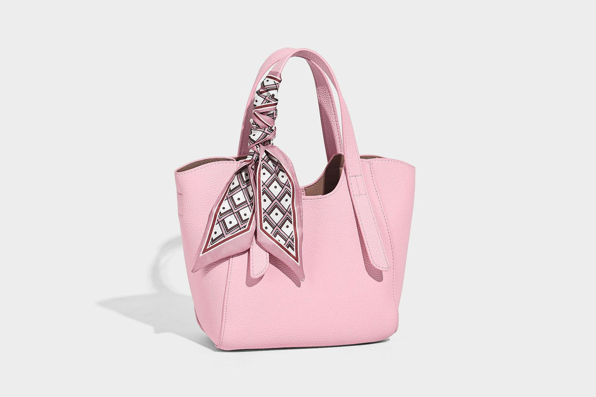 Structured pebbled leather-look tote bag with detachable scarf tie, dual top handles, and adjustable crossbody strap, detail