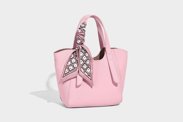 Structured pebbled leather-look tote bag with detachable scarf tie, dual top handles, and adjustable crossbody strap, detail