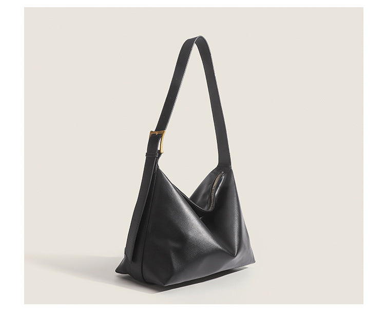 Large slouchy hobo shoulder bag in smooth leather-look finish with single long strap and gold-tone zip closure, detail view