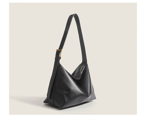 Large slouchy hobo shoulder bag in smooth leather-look finish with single long strap and gold-tone zip closure, detail view