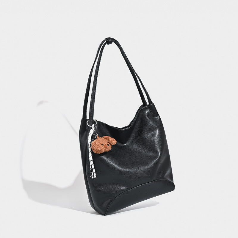 Slouchy leather-look shoulder tote with bear charm tassel in black and coffee brown, detail view 3