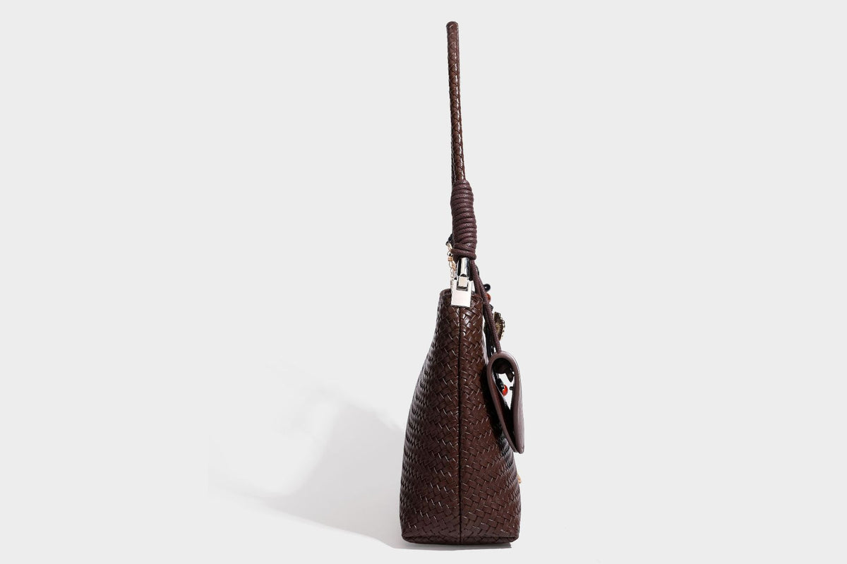 Woven-texture hobo shoulder bag in brown with braided top handle, adjustable crossbody strap, front flap pocket, and, detail