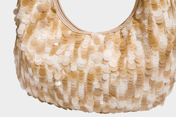 Slouchy crescent hobo shoulder bag covered in overlapping reflective sequin discs with a single integrated strap and top-zip