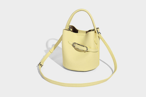 Mini pebbled leather-look bucket bag with front buckle strap, silver-tone hardware, top handle, and detachable shoulder