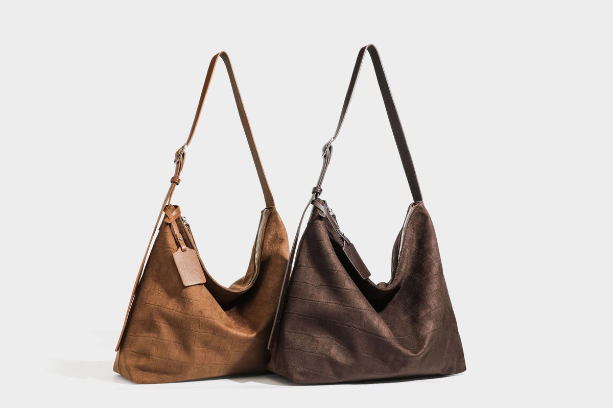 Slouchy hobo shoulder bag in matte croc-embossed leather-look finish with top zip closure and long adjustable strap, detail