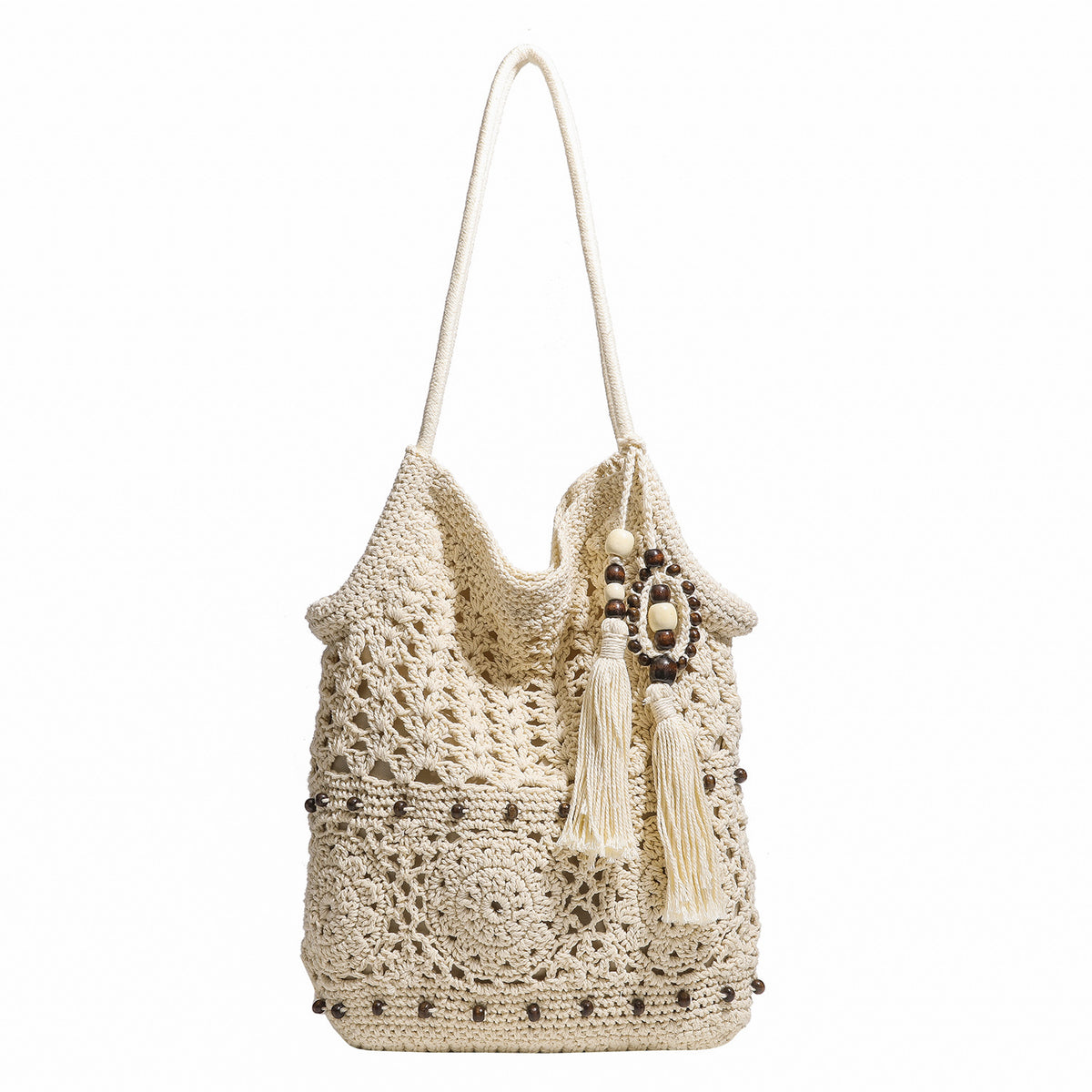 Cream openwork floral crochet tote bag with tassel and wooden bead charm and long rope shoulder straps, detail view 5