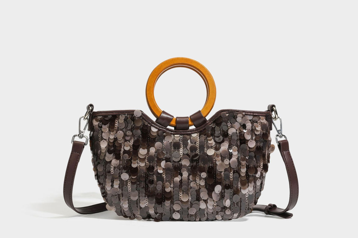 Small sequin half-moon handbag with circular wood-look ring handles and detachable leather-look shoulder strap, detail view