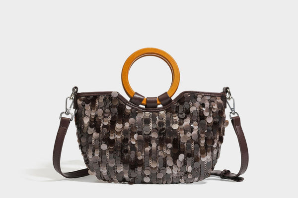 Small sequin half-moon handbag with circular wood-look ring handles and detachable leather-look shoulder strap, detail view
