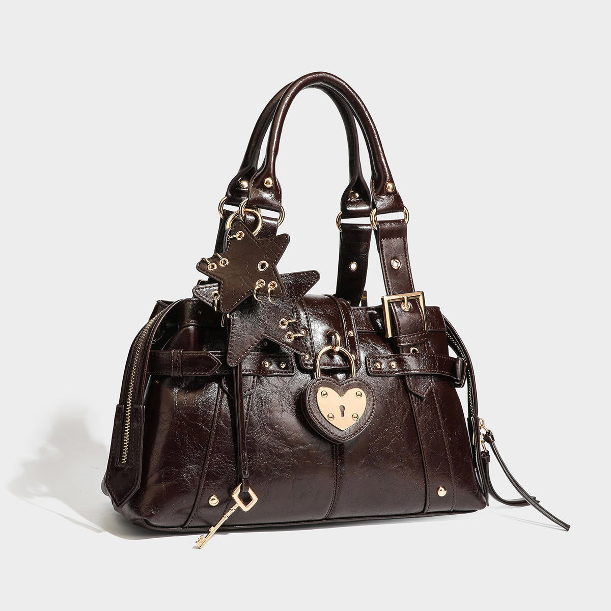 Structured leather-look satchel bag with heart padlock charm, star charm, gold-tone buckle hardware, dual top handles, and