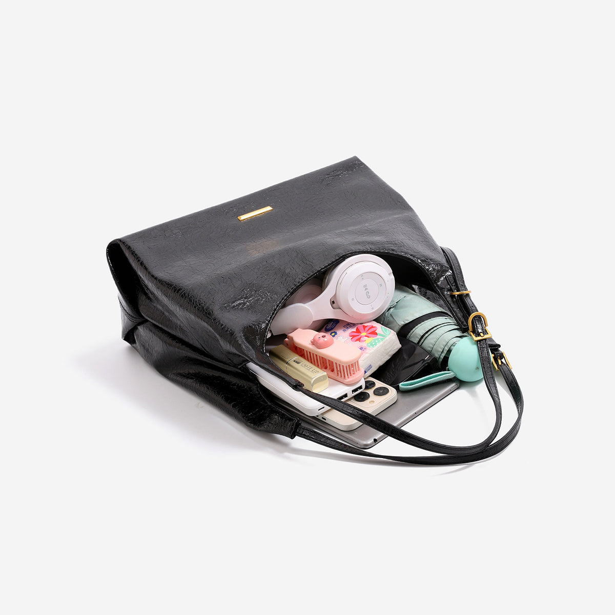 Slouchy hobo shoulder bag in crinkle high-gloss leather-look finish with gold-tone bar hardware and adjustable strap, detail
