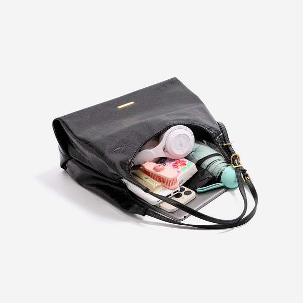 Slouchy hobo shoulder bag in crinkle high-gloss leather-look finish with gold-tone bar hardware and adjustable strap, detail