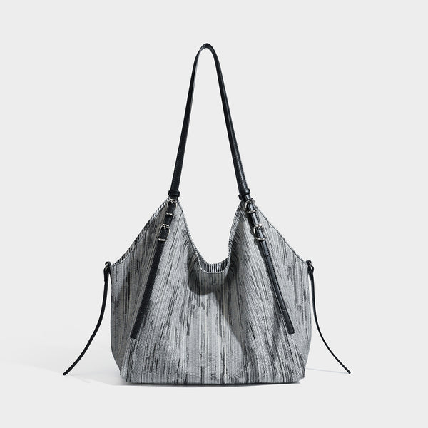 Large slouchy woven-texture shoulder tote bag with slim leather-look straps, side cinch ties, and silver-tone hardware