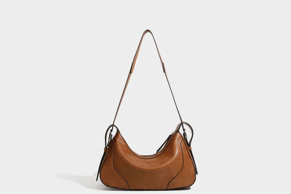 Slouchy crescent hobo shoulder bag in dark brown pebbled leather-look finish with zip top and long shoulder strap, detail