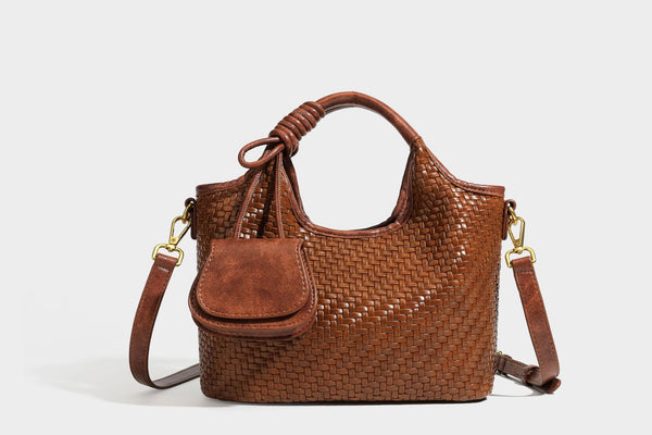 Woven leather-look tote bag in mocha brown with knotted top handle, front flap pocket, and detachable crossbody strap with