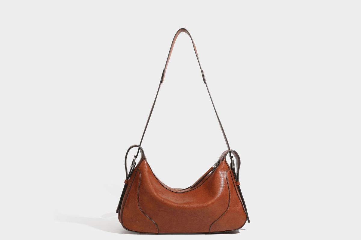 Slouchy crescent hobo shoulder bag in dark brown pebbled leather-look finish with zip top and long shoulder strap, detail