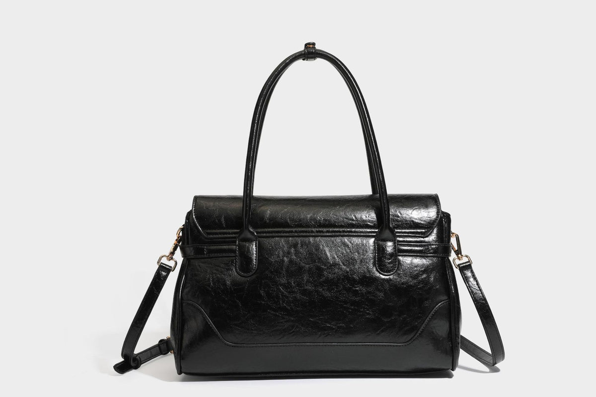 Structured glossy leather-look satchel bag with flap closure, gold-tone buckle accents, double top handles, detachable