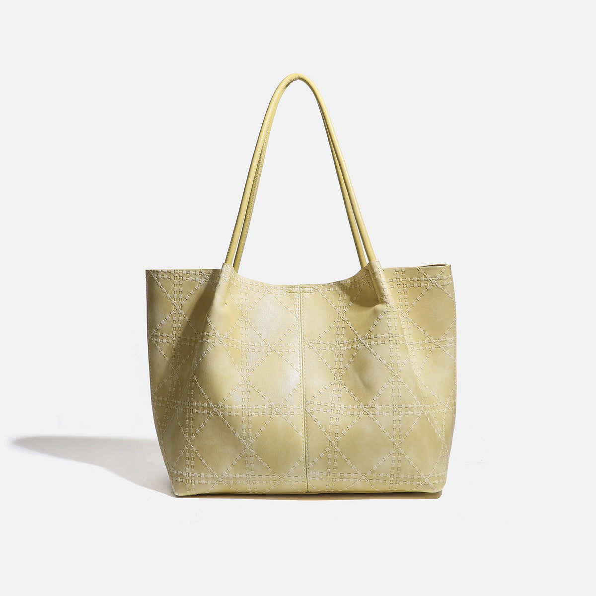 Large open-top tote bag with raised diamond-lattice stitching, long double shoulder handles, and gold-tone magnetic snap