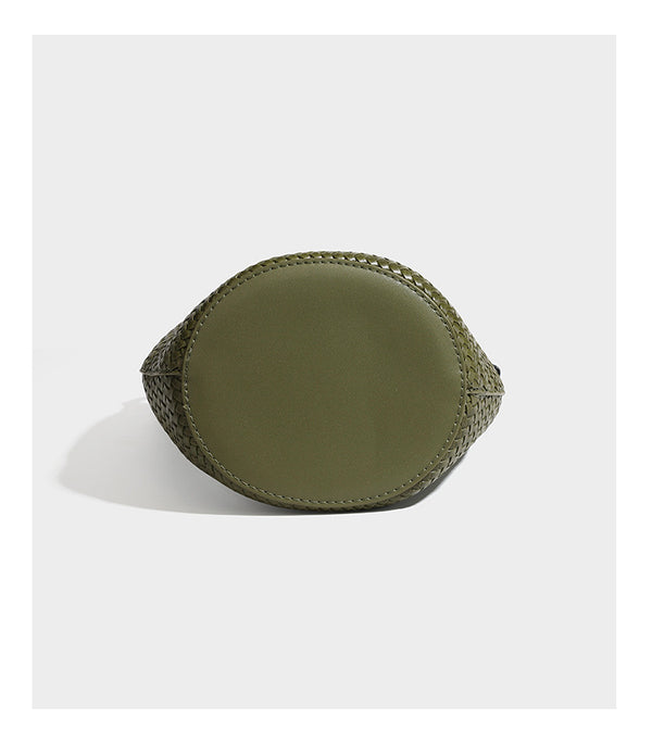 Olive green woven leather-look bucket bag with braided crossbody strap, knotted adjustment, and gold-tone tassel charm with