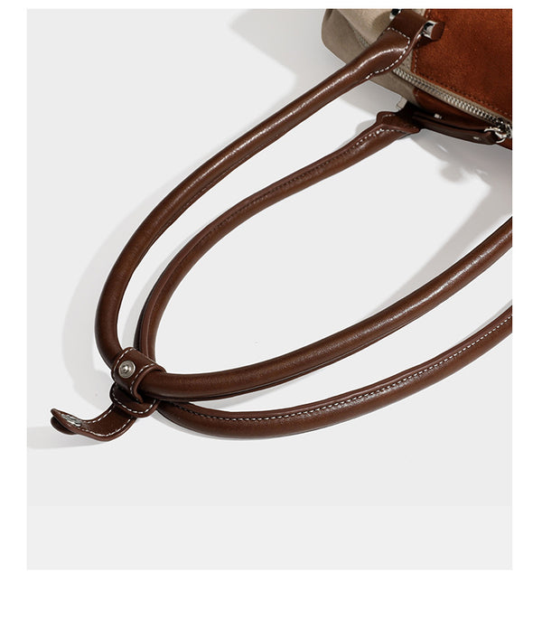 Patchwork suede-look barrel shoulder bag in brown, rust, tan, beige, and gray panels with double leather-look straps and