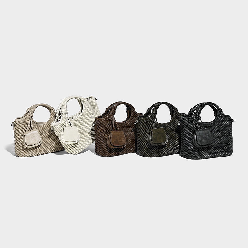 Structured woven-texture bucket bag with knotted top handle, front flap pocket, and detachable silver-tone crossbody strap