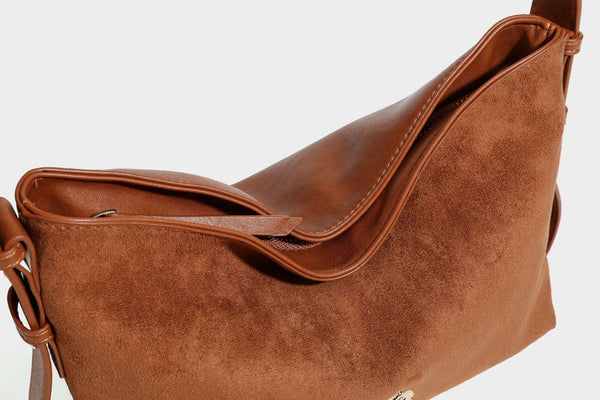 Slouchy suede-finish brown shoulder bag with long single strap and small gold-tone logo emblem on front, detail view 37