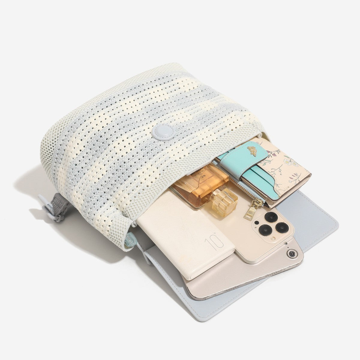 Small structured woven-body flap bag with smooth leather-look front panel, knotted top handle, and wide adjustable shoulder