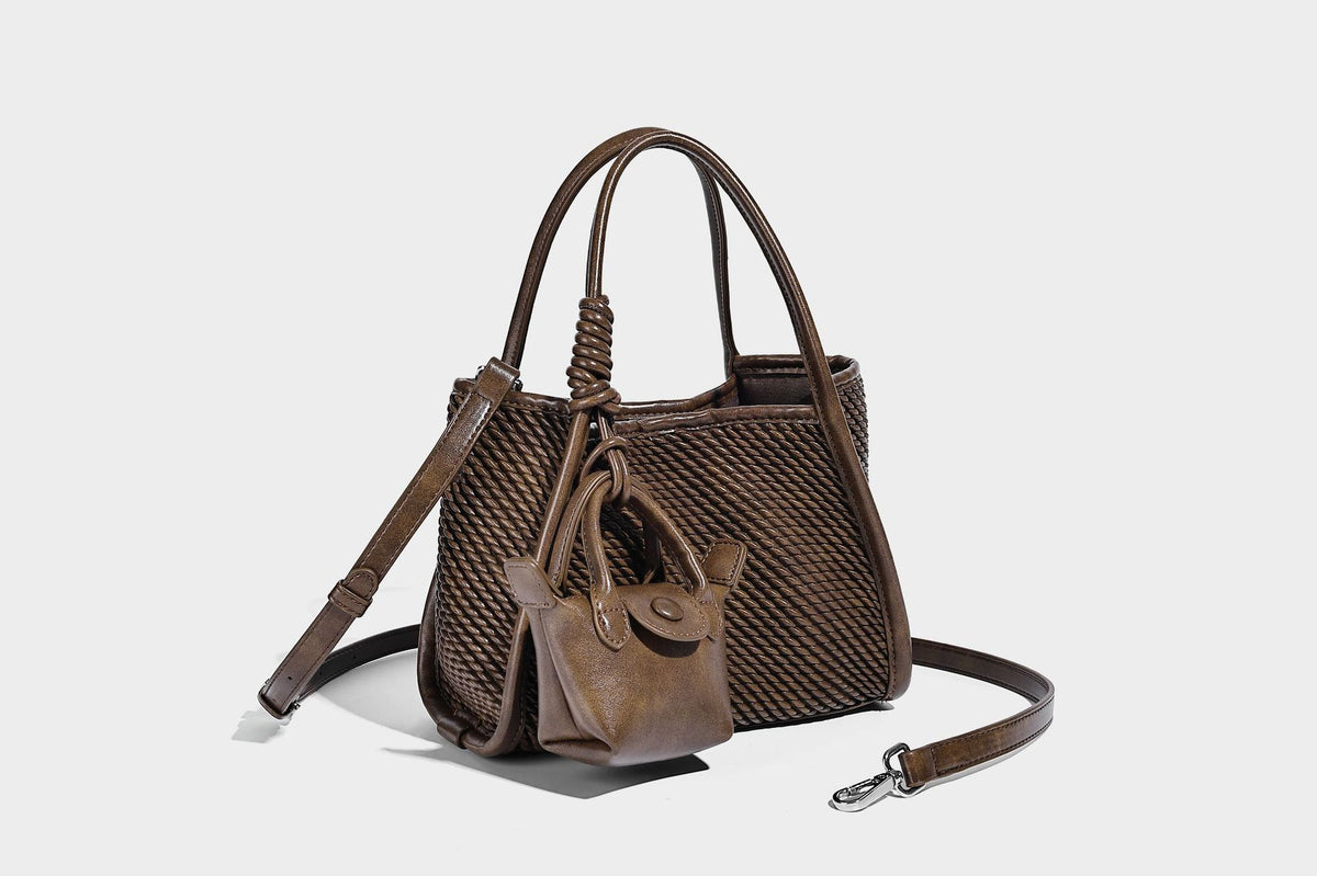 Large structured woven rope-texture tote bag with smooth leather-look trim, knotted dual top handles, detachable mini front