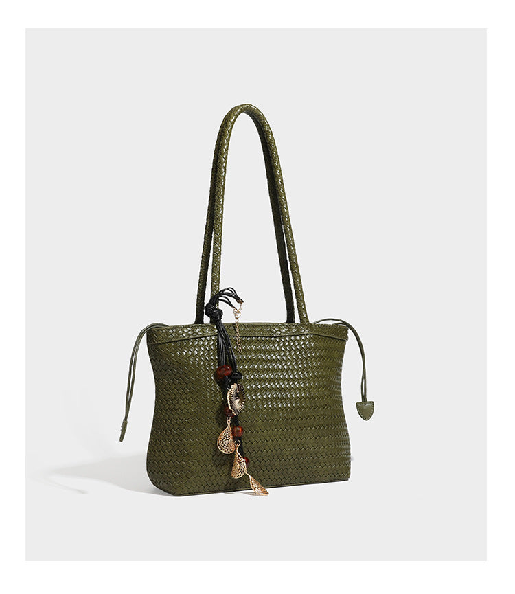 Structured woven leather-look tote bag in dark brown with long shoulder straps, side drawstring ties, and gold filigree