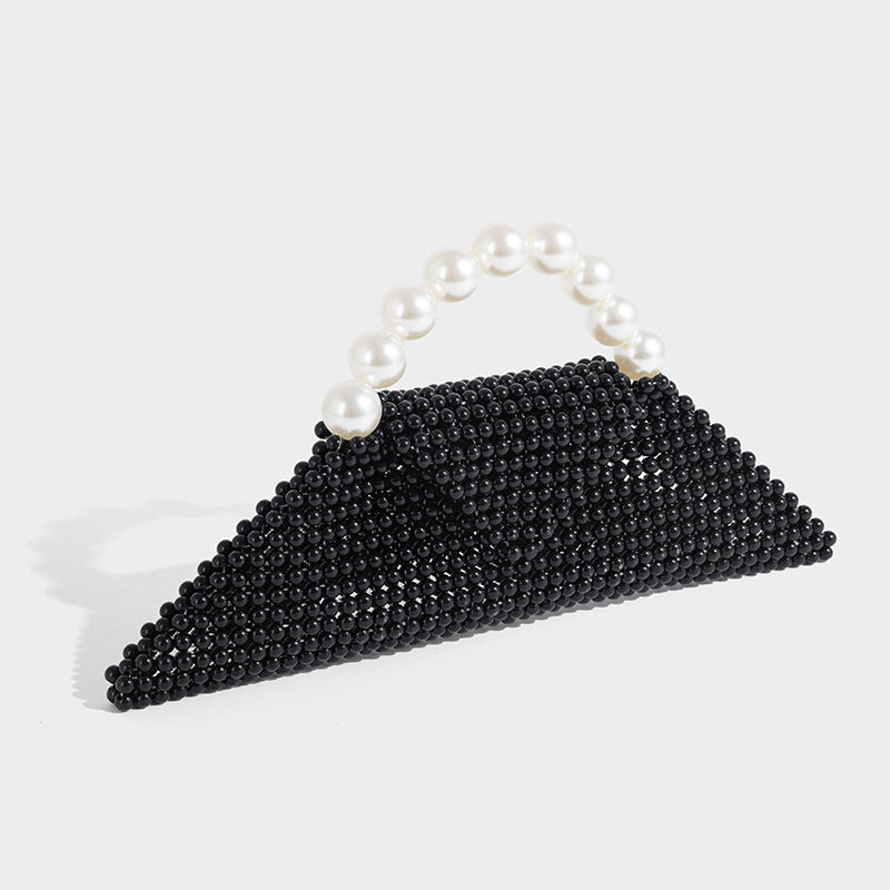 Small structured triangle clutch bag covered in glossy pearl beads with an arched pearl top handle and silver snap closure