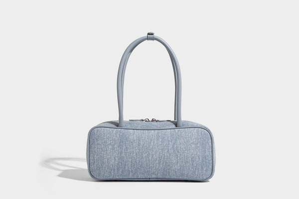 Small structured light blue denim-texture bowling bag with white floral bead embroidery, dual rounded top handles, and
