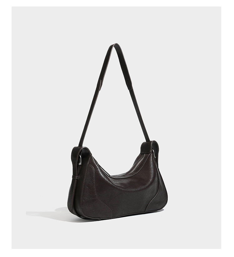 Dark brown curved zip-top hobo shoulder bag with slim adjustable strap and silver-tone hardware, detail view 11