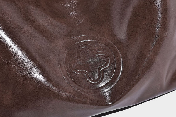 Glossy slouchy hobo shoulder bag with adjustable strap and embossed floral emblem, detail view 24