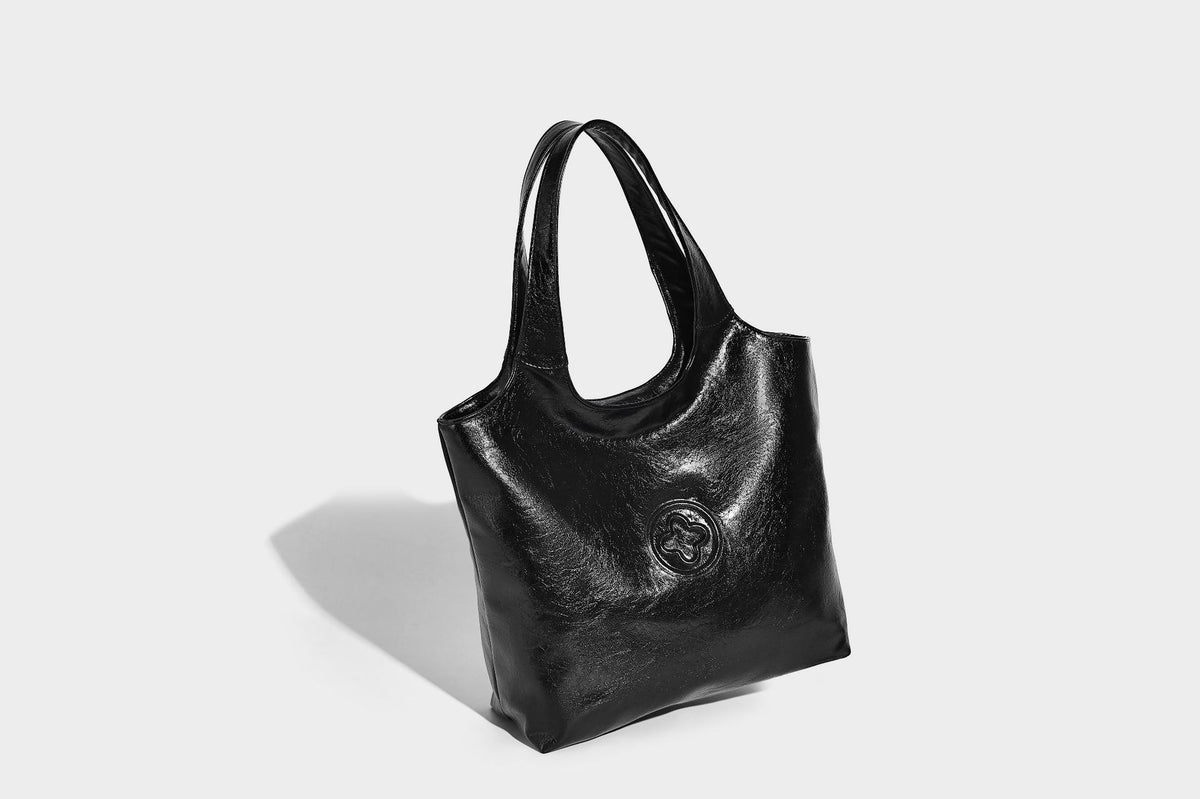 Glossy oil-wax leather-look open-top tote shoulder bag with embossed circular logo and long double straps, detail view 17