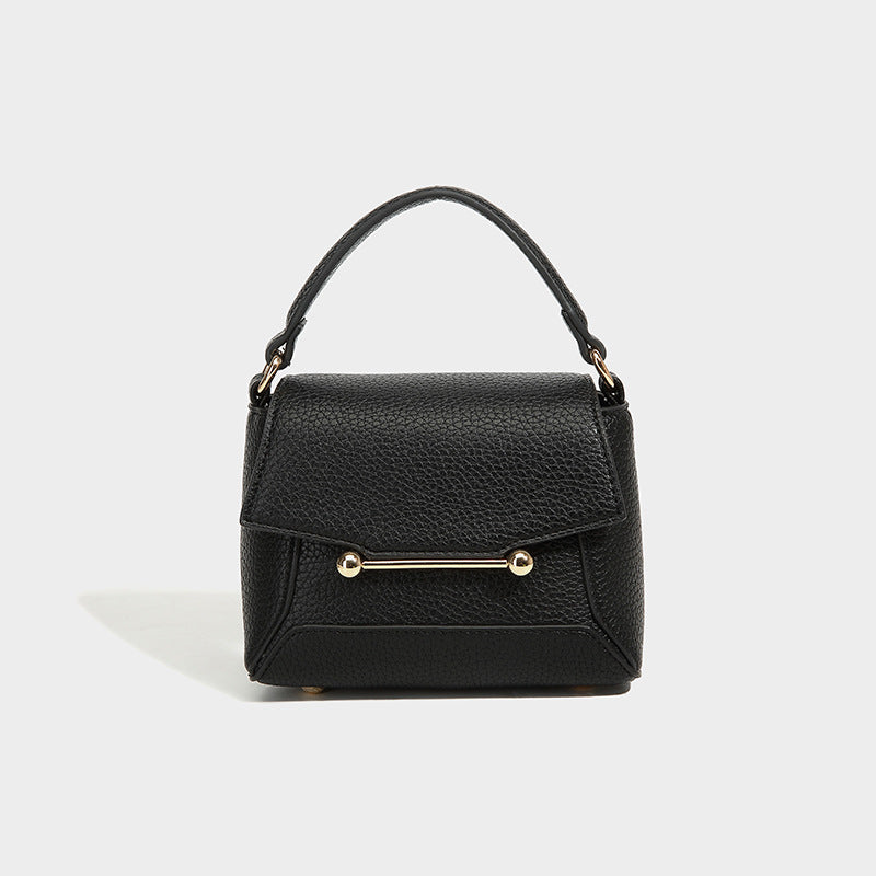 Small structured pebbled flap mini satchel with gold-tone bar hardware, short top handle, and detachable crossbody strap