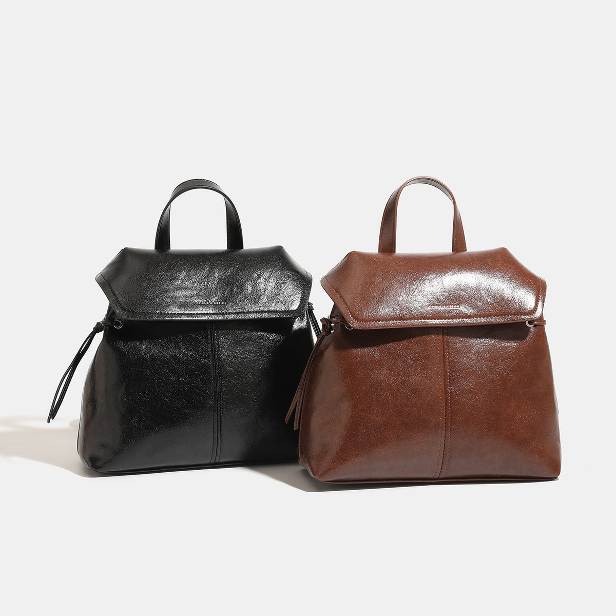 Large vintage leather-look backpack handbag with rope-knot flap closure and top handle, detail view 2